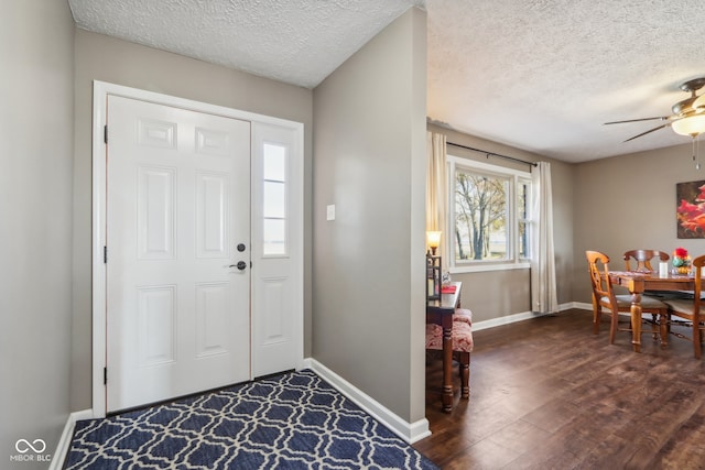 foyer featuring a textured ceiling, dark hardwood / wood-style floors, and ceiling fan