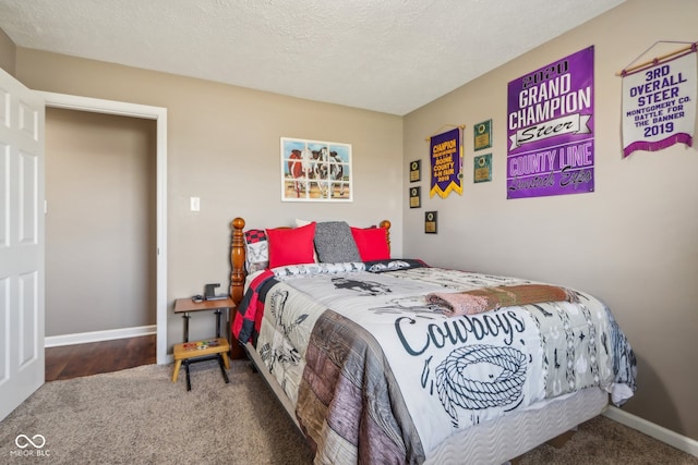 carpeted bedroom with a textured ceiling