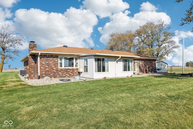 back of house featuring central AC unit, a lawn, and a storage unit