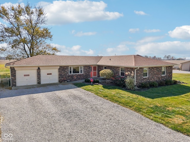 ranch-style home with a front lawn and a garage