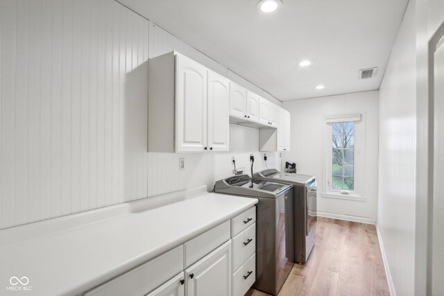 5784 N 600 E, Greenfield, IN 46140 - washroom with washing machine and dryer, cabinet space, light wood-style flooring, recessed lighting, and baseboards