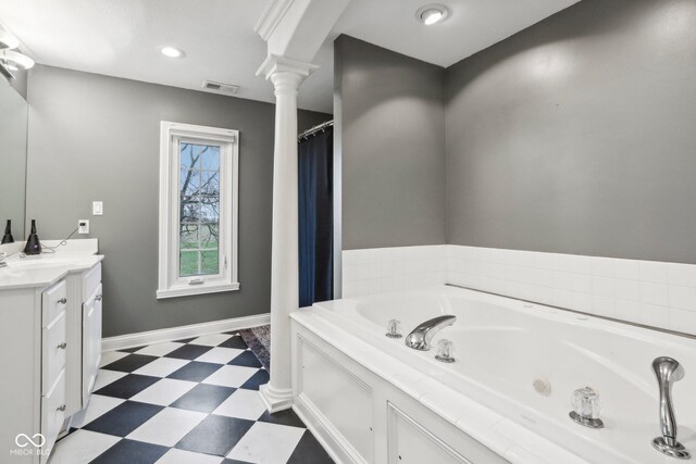 5784 N 600 E, Greenfield, IN 46140 - bathroom with tile patterned floors, ornate columns, vanity, a jetted tub, and baseboards