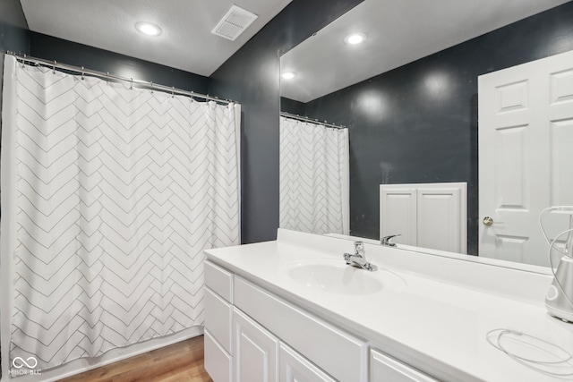 bathroom with vanity and wood-type flooring