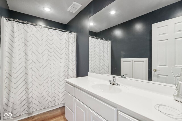 5784 N 600 E, Greenfield, IN 46140 - full bath with vanity, wood finished floors, a shower with shower curtain, and recessed lighting