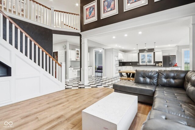 5784 N 600 E, Greenfield, IN 46140 - living room featuring ornate columns, a high ceiling, recessed lighting, a decorative wall, and light wood-style flooring