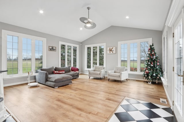 sunroom with a wealth of natural light and lofted ceiling