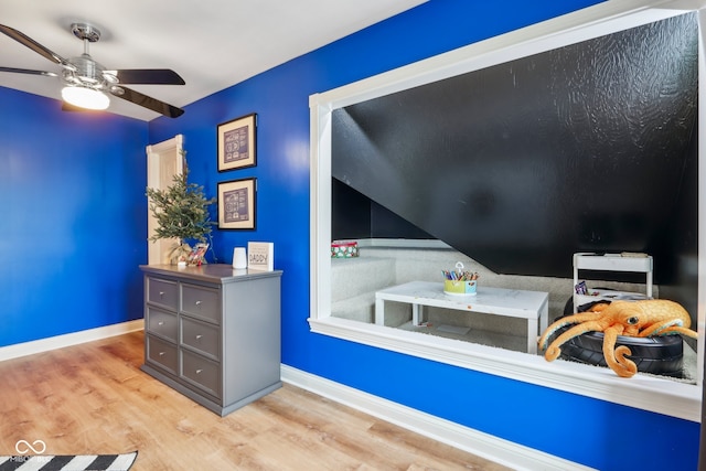 bedroom with ceiling fan and light hardwood / wood-style floors