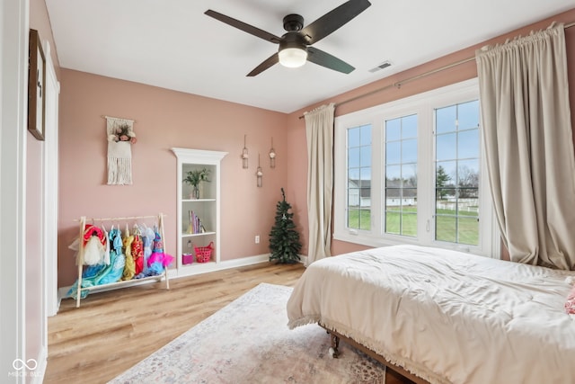 bedroom with ceiling fan and light hardwood / wood-style flooring