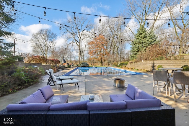 view of patio with outdoor lounge area and a fenced in pool