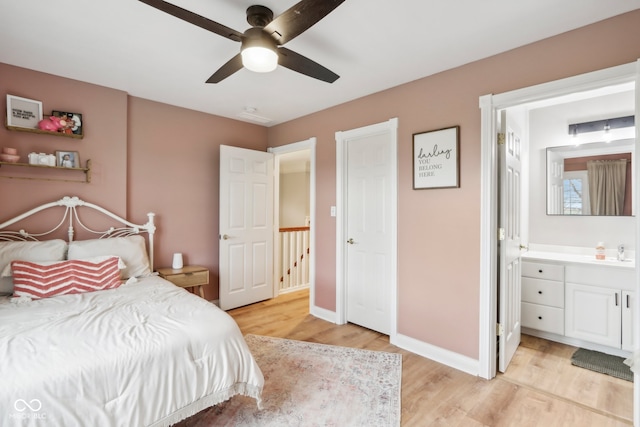 bedroom with ceiling fan, sink, ensuite bathroom, and light wood-type flooring