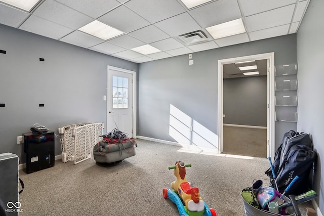 playroom with carpet flooring and a drop ceiling