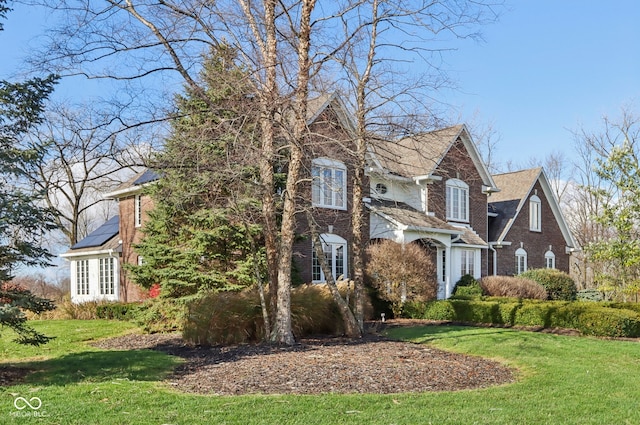 view of property featuring solar panels and a front lawn