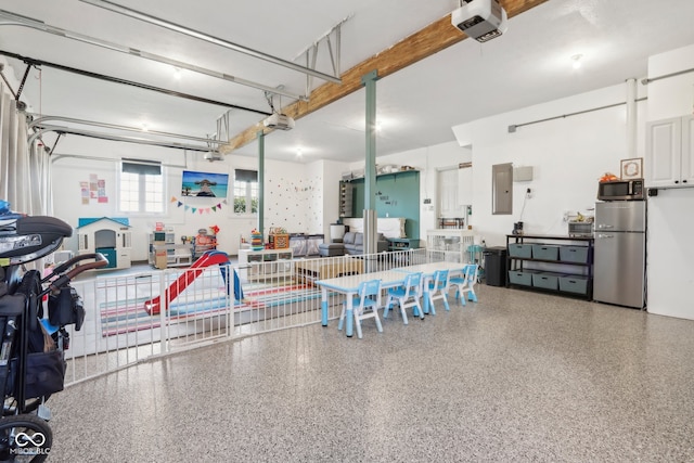 garage with electric panel, a pool, a garage door opener, and stainless steel refrigerator