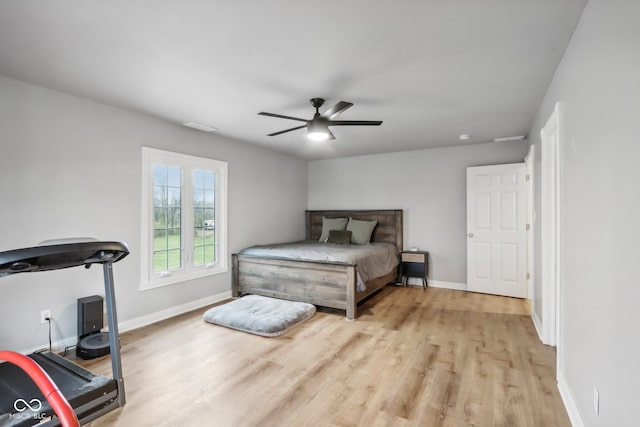 bedroom with light hardwood / wood-style floors and ceiling fan