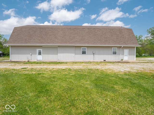 5784 N 600 E, Greenfield, IN 46140 - rear view of house with a shingled roof, a lawn, and an outdoor structure