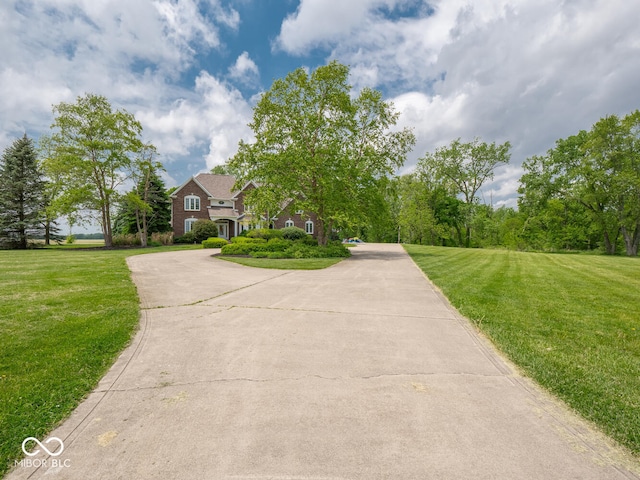 5784 N 600 E, Greenfield, IN 46140 - view of front facade with a front yard and curved driveway