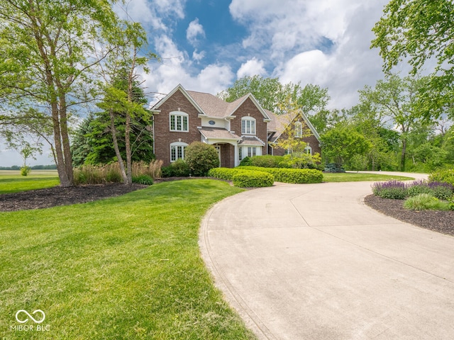 5784 N 600 E, Greenfield, IN 46140 - colonial house featuring curved driveway, a front yard, and brick siding