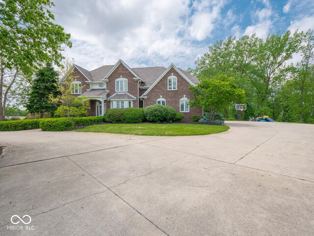 5784 N 600 E, Greenfield, IN 46140 - view of front of home featuring brick siding, a front lawn, and concrete driveway