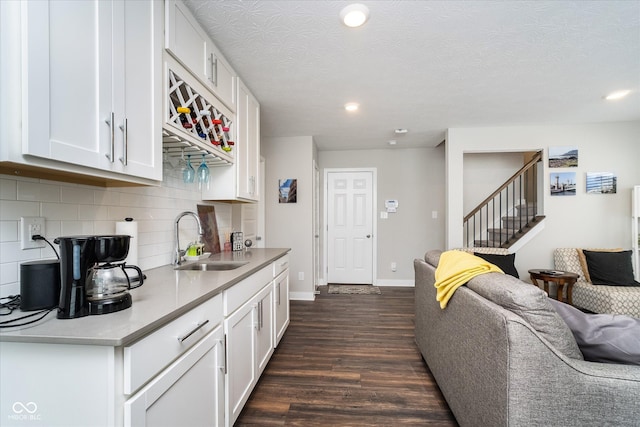 7282 Zanesville Rd, Carmel, IN 46033 - kitchen with recessed lighting, dark wood finished floors, a sink, white cabinetry, and tasteful backsplash