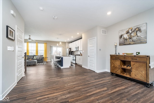 7282 Zanesville Rd, Carmel, IN 46033 - living room featuring recessed lighting, baseboards, ceiling fan, visible vents, and dark wood-style floors