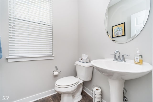 7282 Zanesville Rd, Carmel, IN 46033 - half bath with toilet, baseboards, a healthy amount of sunlight, and wood finished floors