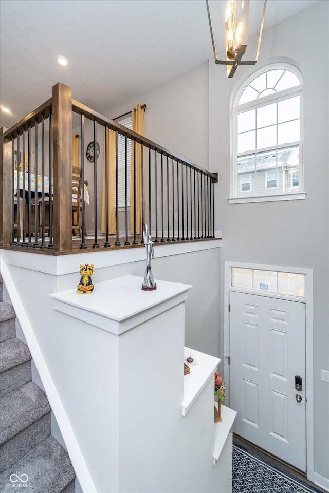 7282 Zanesville Rd, Carmel, IN 46033 - stairway with a chandelier and recessed lighting