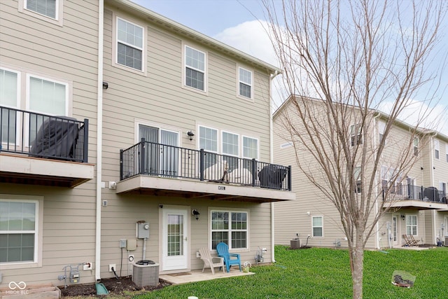 7282 Zanesville Rd, Carmel, IN 46033 - back of house with central air condition unit, a yard, and a balcony