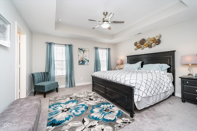 7282 Zanesville Rd, Carmel, IN 46033 - bedroom featuring baseboards, ceiling fan, visible vents, a raised ceiling, and light carpet