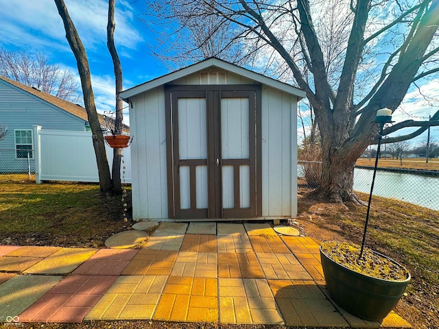 view of shed featuring fence