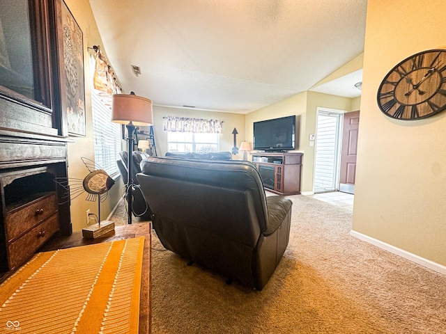 living room featuring lofted ceiling, carpet, and baseboards