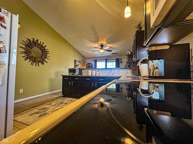 game room featuring baseboards, vaulted ceiling, and a ceiling fan