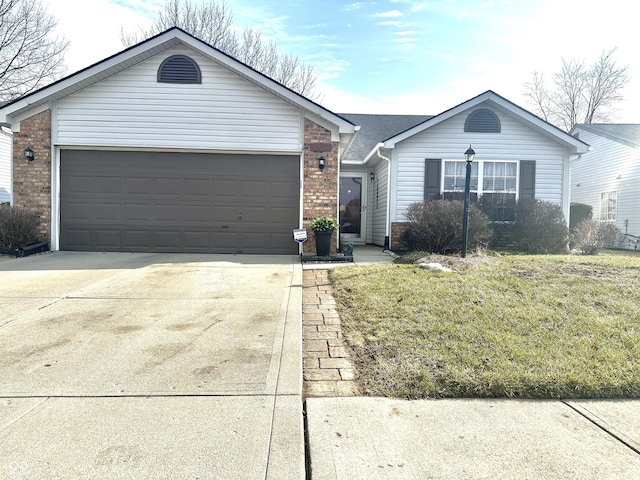 ranch-style home featuring a garage, a front lawn, concrete driveway, and brick siding