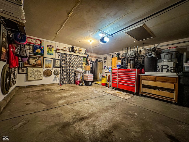 garage with a workshop area and a garage door opener