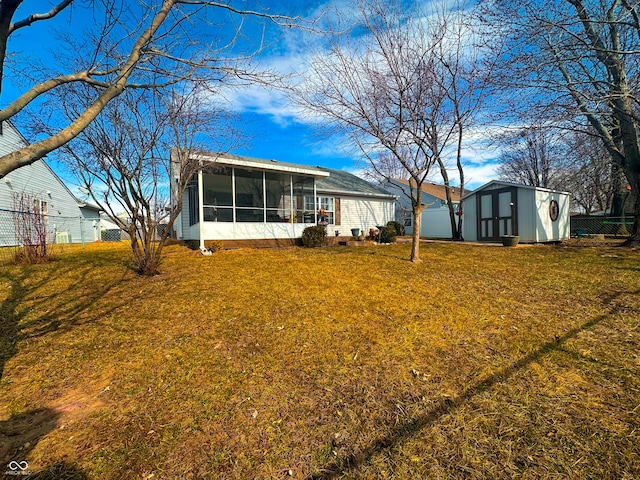 exterior space with a sunroom, a storage shed, fence, and an outdoor structure