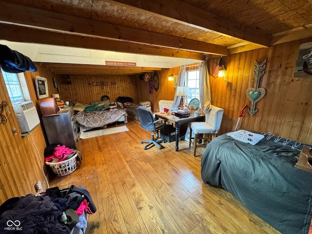 bedroom with wood walls, wooden ceiling, beam ceiling, and hardwood / wood-style floors