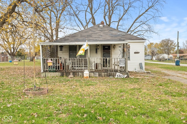 bungalow with a front lawn and a porch