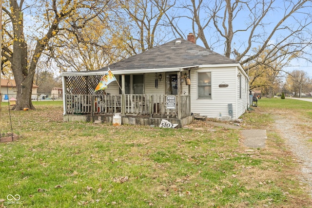 bungalow-style house with covered porch and a front yard