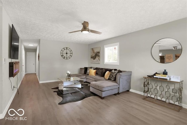 living room featuring a textured ceiling, hardwood / wood-style flooring, and ceiling fan