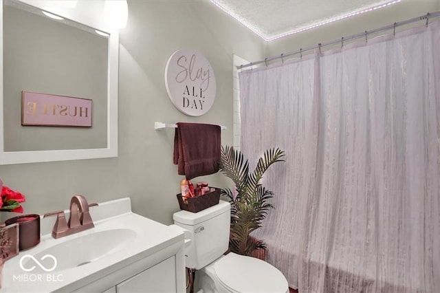 full bathroom with shower / bath combo, vanity, and toilet