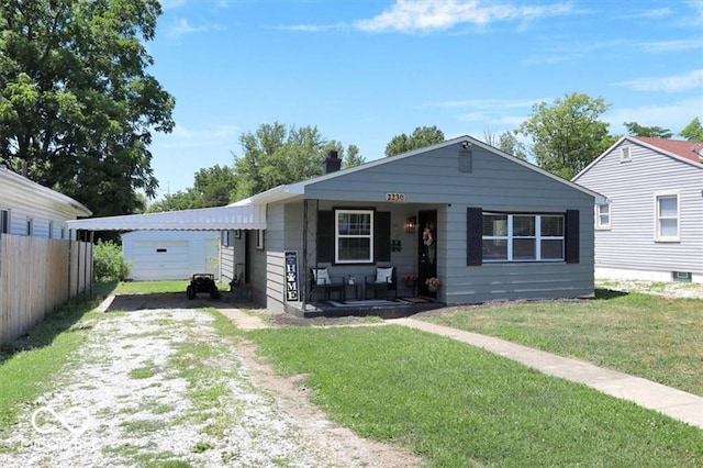 view of front of property with a front yard, covered porch, and a garage