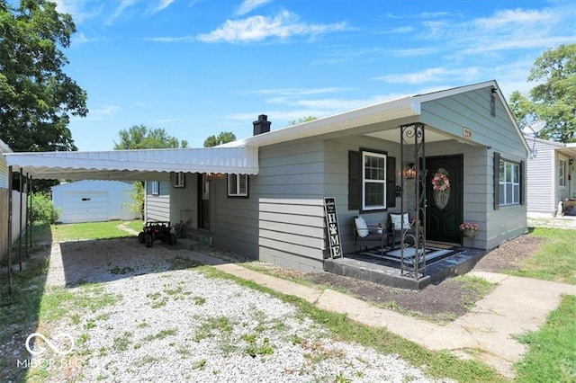 ranch-style house with a porch and a carport