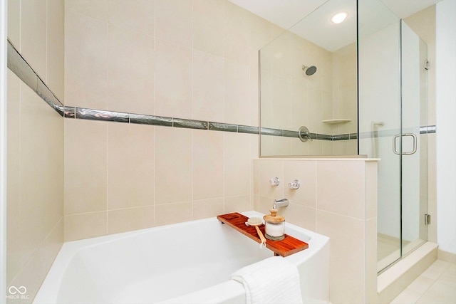 bathroom featuring shower with separate bathtub