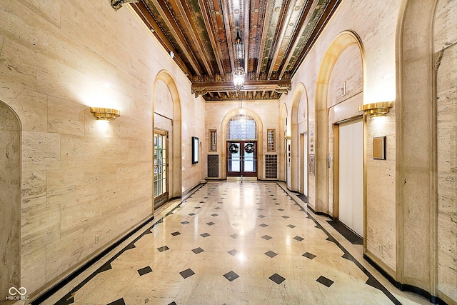 hallway with beam ceiling and a towering ceiling