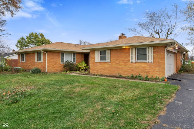 ranch-style home featuring a garage and a front lawn