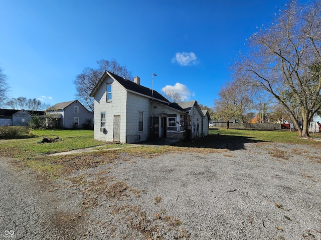 view of side of home with a yard