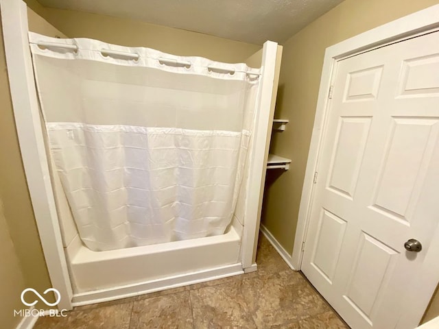 bathroom with shower / bathtub combination with curtain