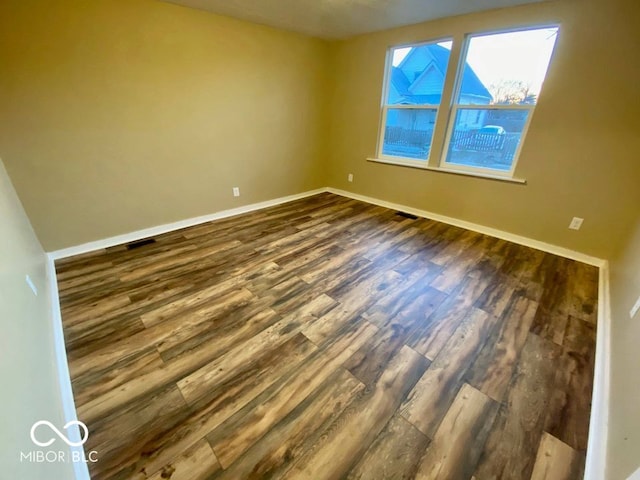 spare room with dark hardwood / wood-style flooring