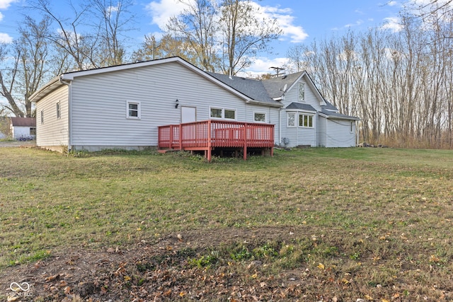 rear view of property featuring a deck and a lawn