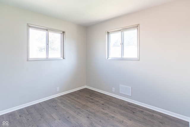 spare room with dark hardwood / wood-style flooring