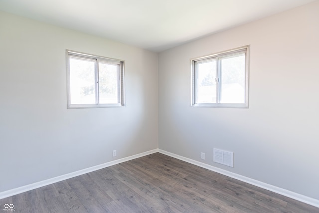 spare room with dark wood-type flooring